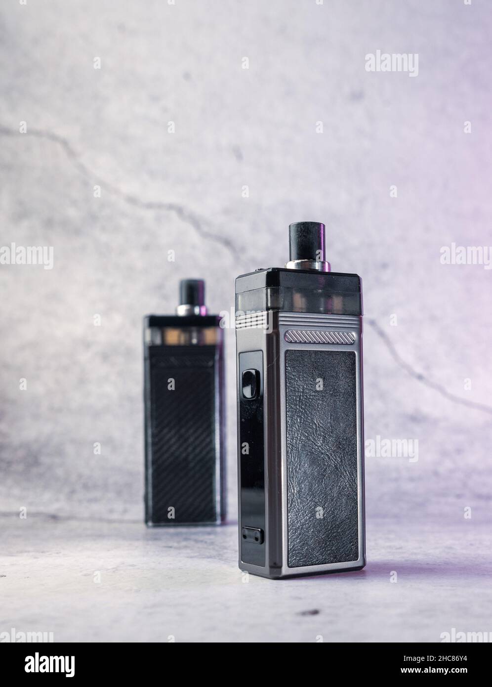 two vape electronic cigarettes on a gray background Stock Photo