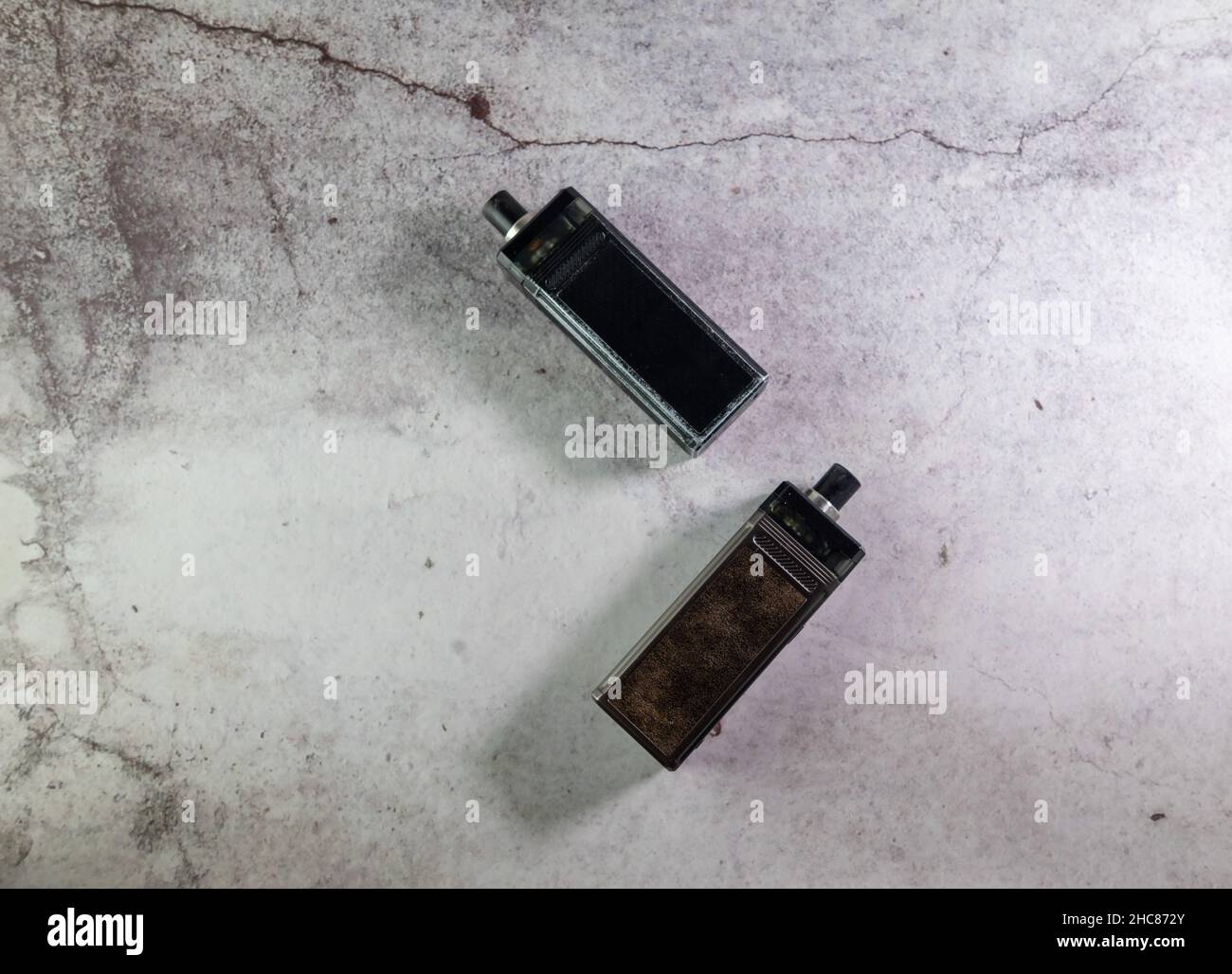 two vape electronic cigarettes on a gray background Stock Photo