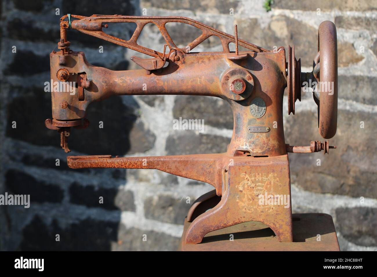 Old rusty sewing machine outdoors Stock Photo Alamy
