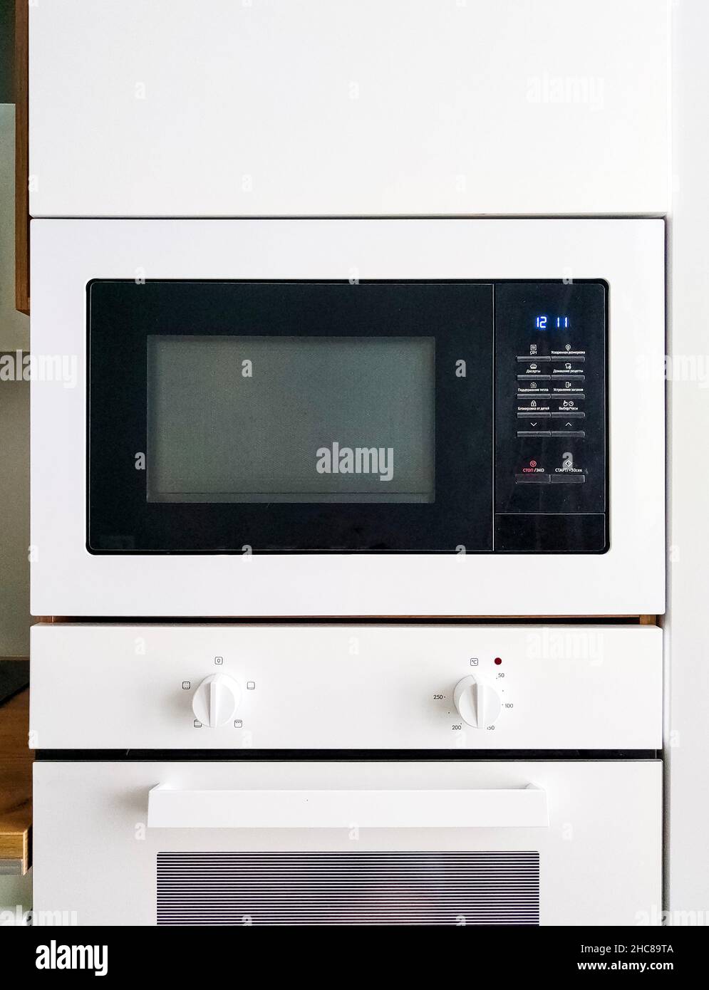 White microwave oven in modern scandi kitchen Stock Photo