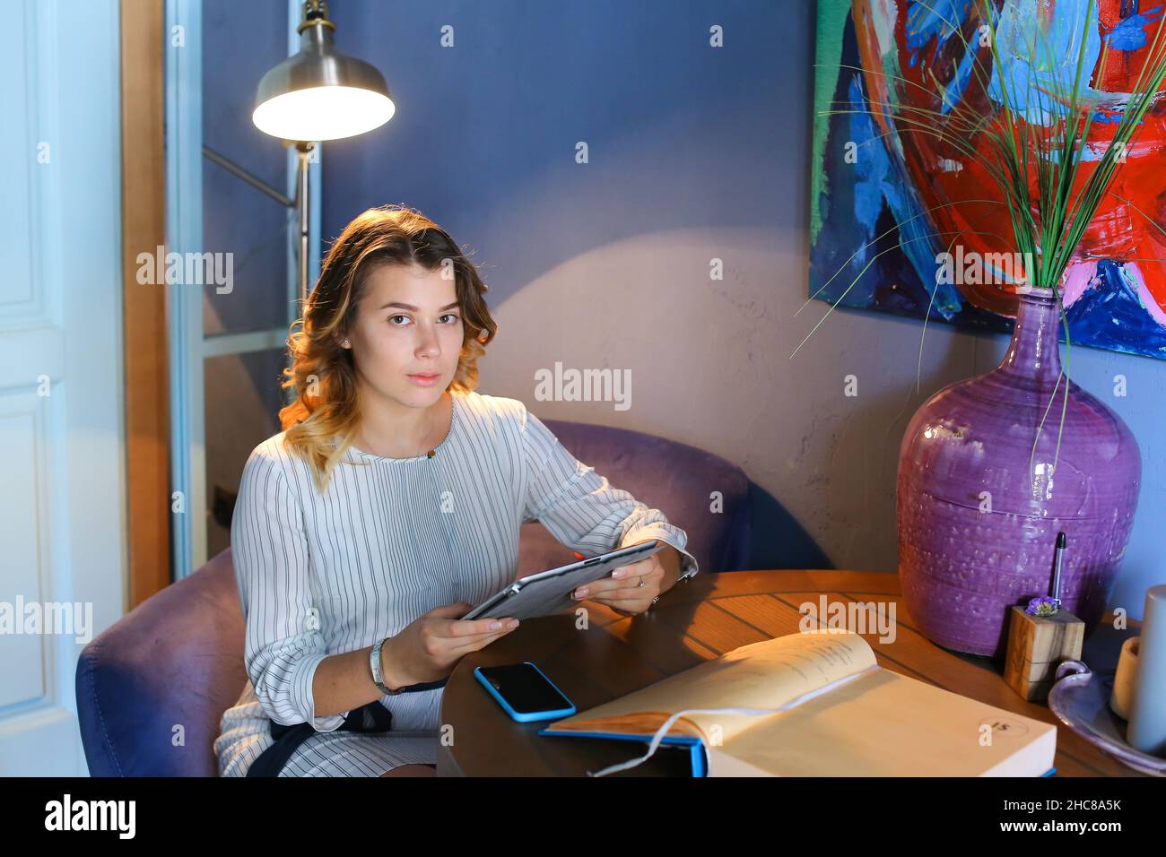 Female using technology in cafe phone tablet Stock Photo