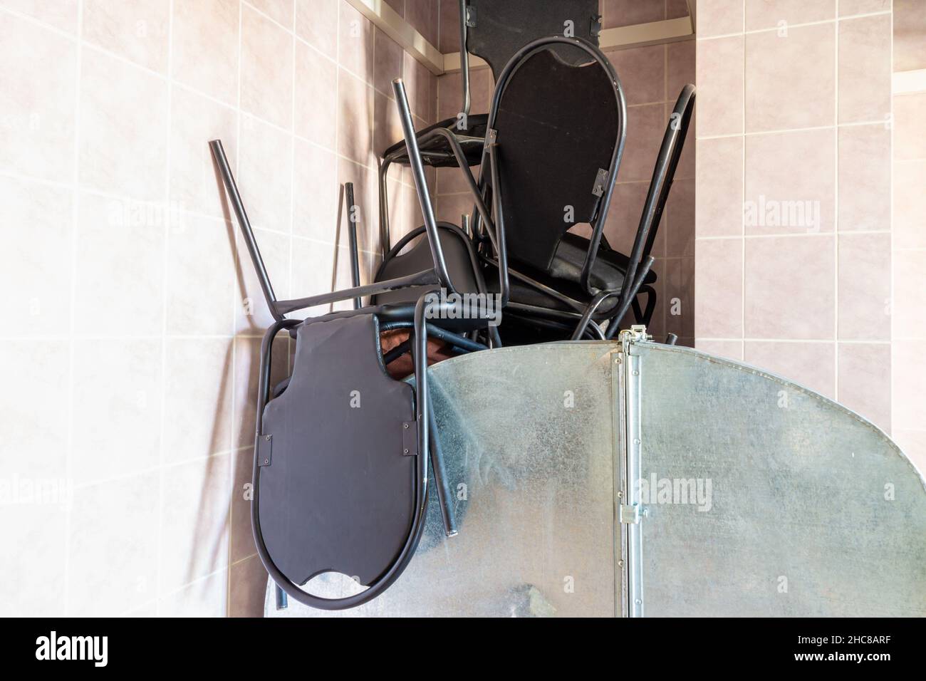 old broken cheap office chairs made of black ecoleather and metal are