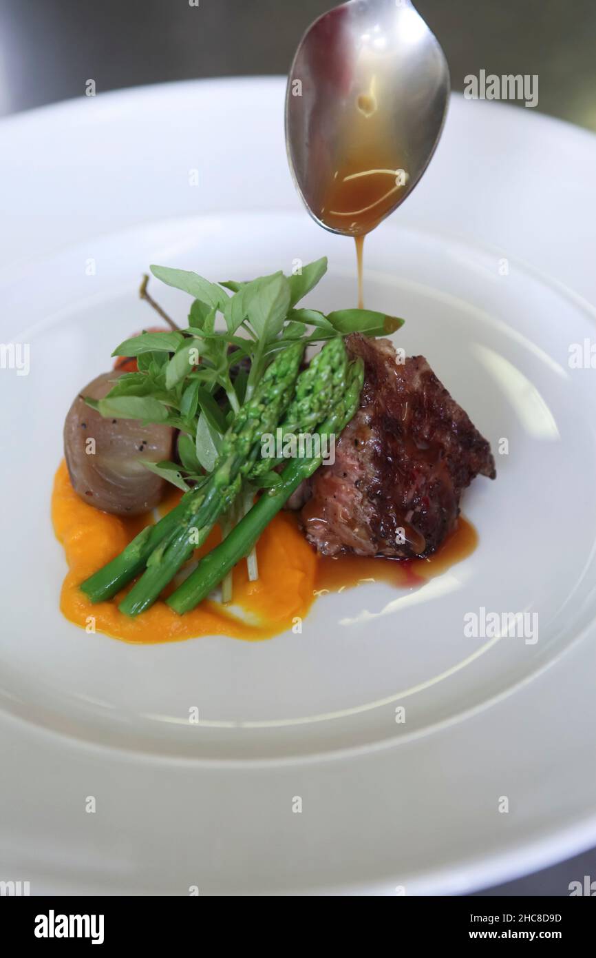 Char Grilled fillet beefsteak with asparagus onions and pumpkin puree Stock Photo