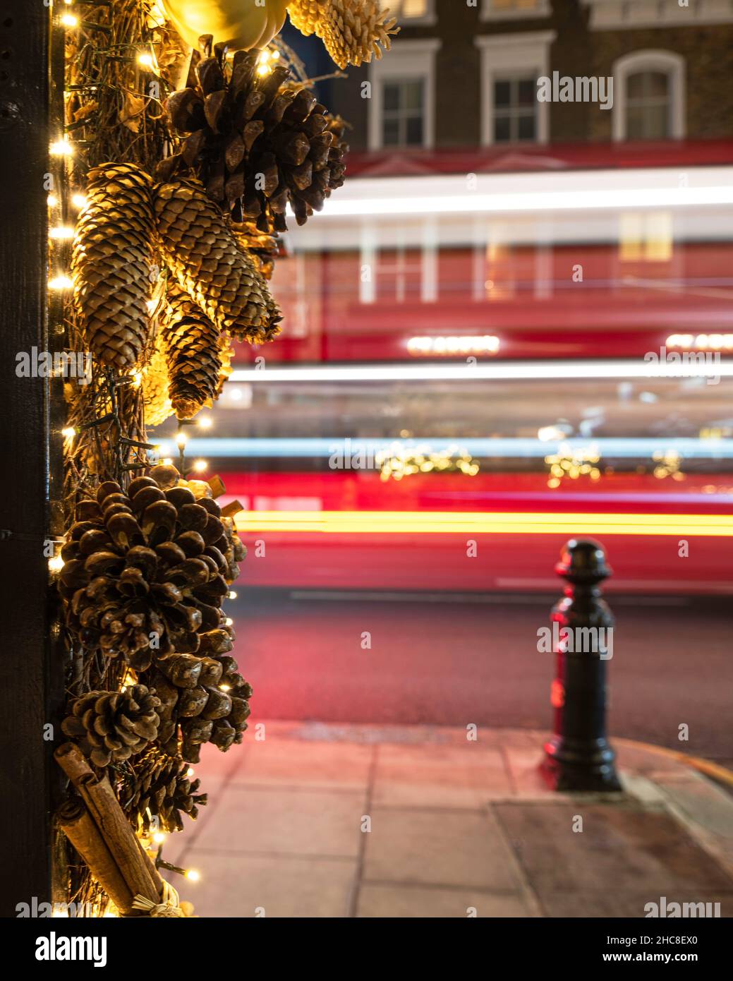 Close up of Christmas decorations with London bus trails in the background Stock Photo