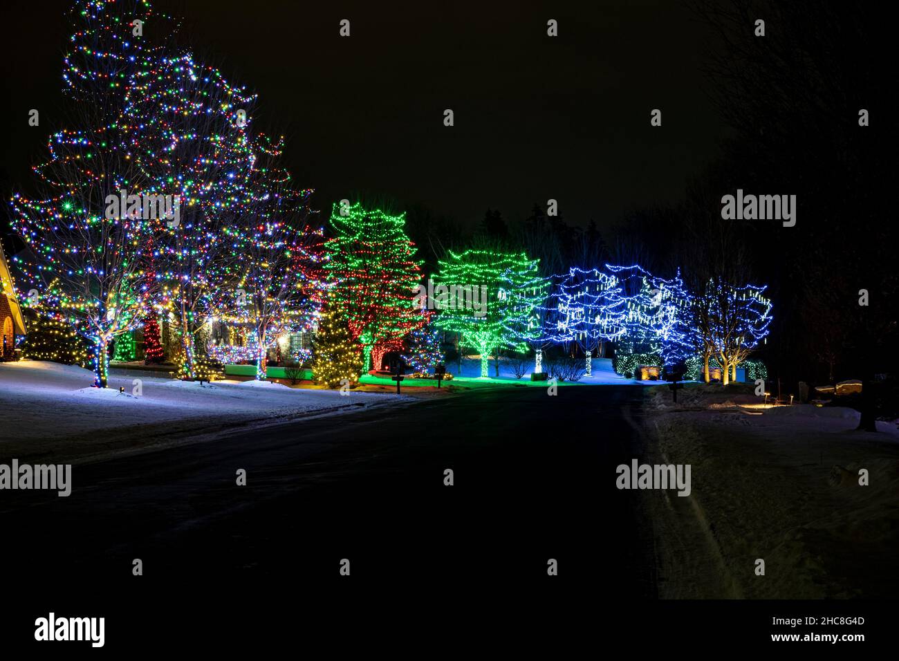 colorful holiday lights display in suburban neighborhood Stock Photo