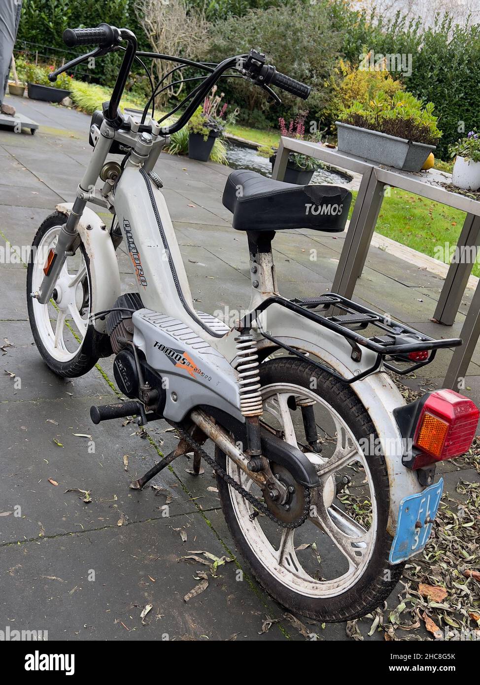 Back view of an old rusty Tommos scooter parked in the yard Stock Photo ...