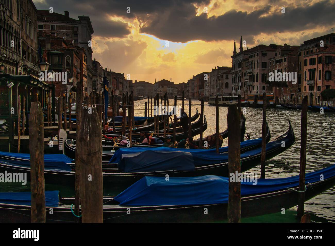 Row of gondolas in The Grand Canal, Venice at the sunset Stock Photo ...