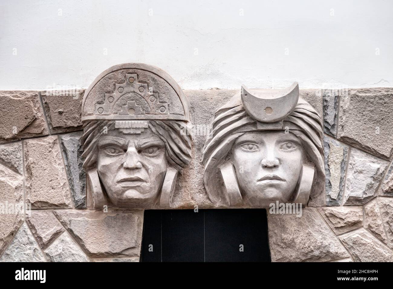 Relief of an Inca man and woman on a building wall in San Blas, Cusco, Sacred Valley, Peru Stock Photo