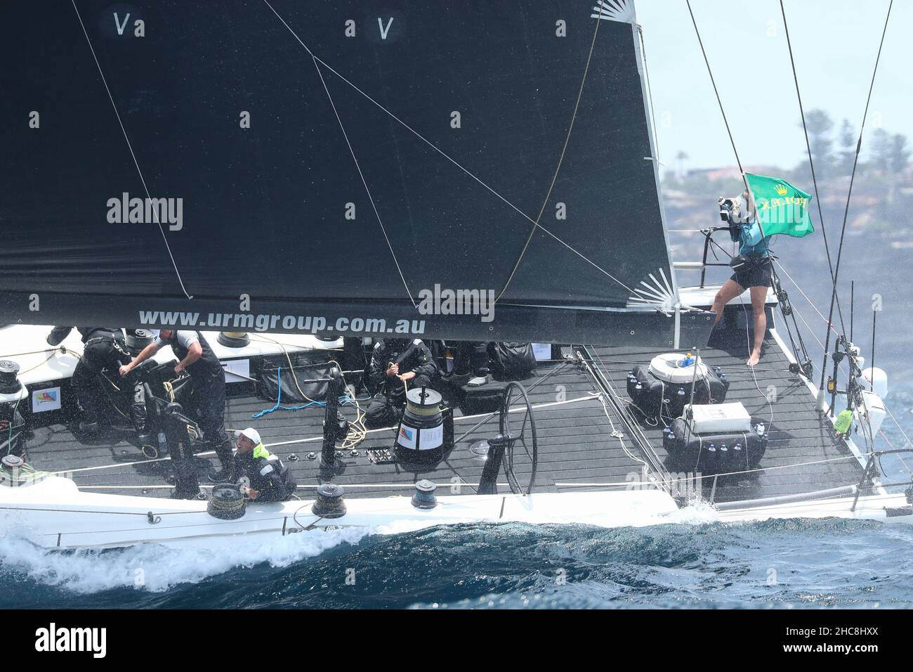 Sydney Harbour, Sydney, Australia. 26th Dec, 2021. Rolex Sydney Hobart Yacht Race; crew of URM skippered by Marcus Ashley-Jones work the rigging as the yacht cuts through the heavy swell to the open ocean Credit: Action Plus Sports/Alamy Live News Stock Photo