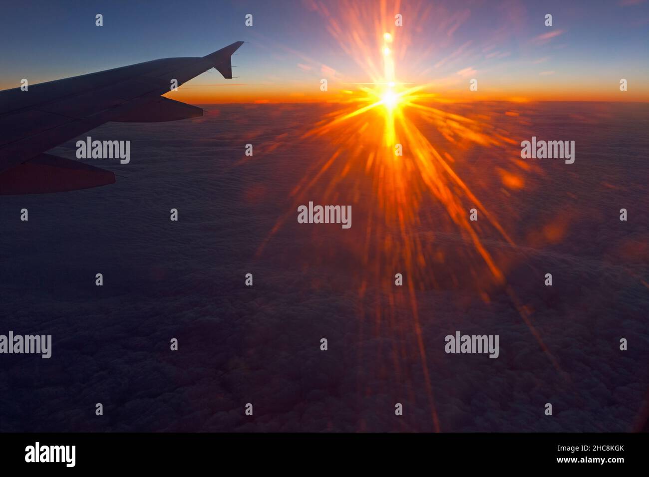 Sunset above the cloud base, viewed from a passenger plane on a flight from Munich to Cyprus, in winter Stock Photo