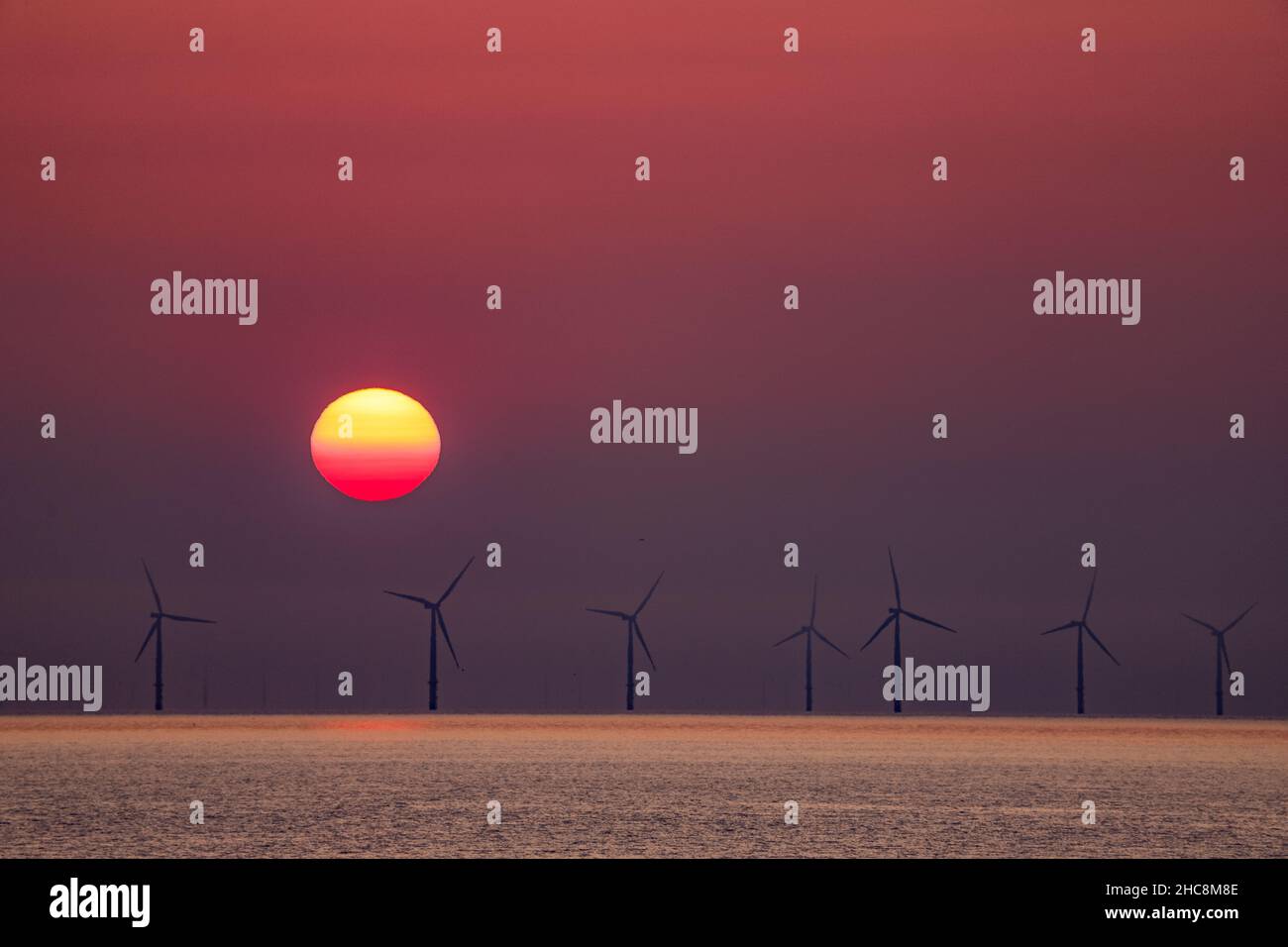 Sunset over the Gwynt-y-Môr offshore wind farm, Colwyn Bay, North Wales Stock Photo