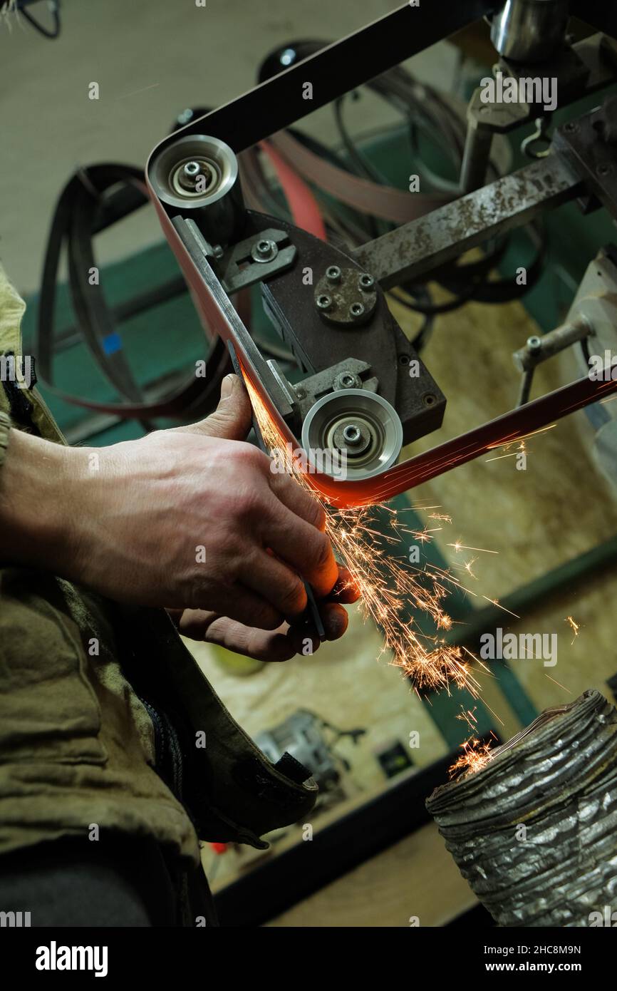 Sparks grinding wheel while knife sharpening. Stock Photo