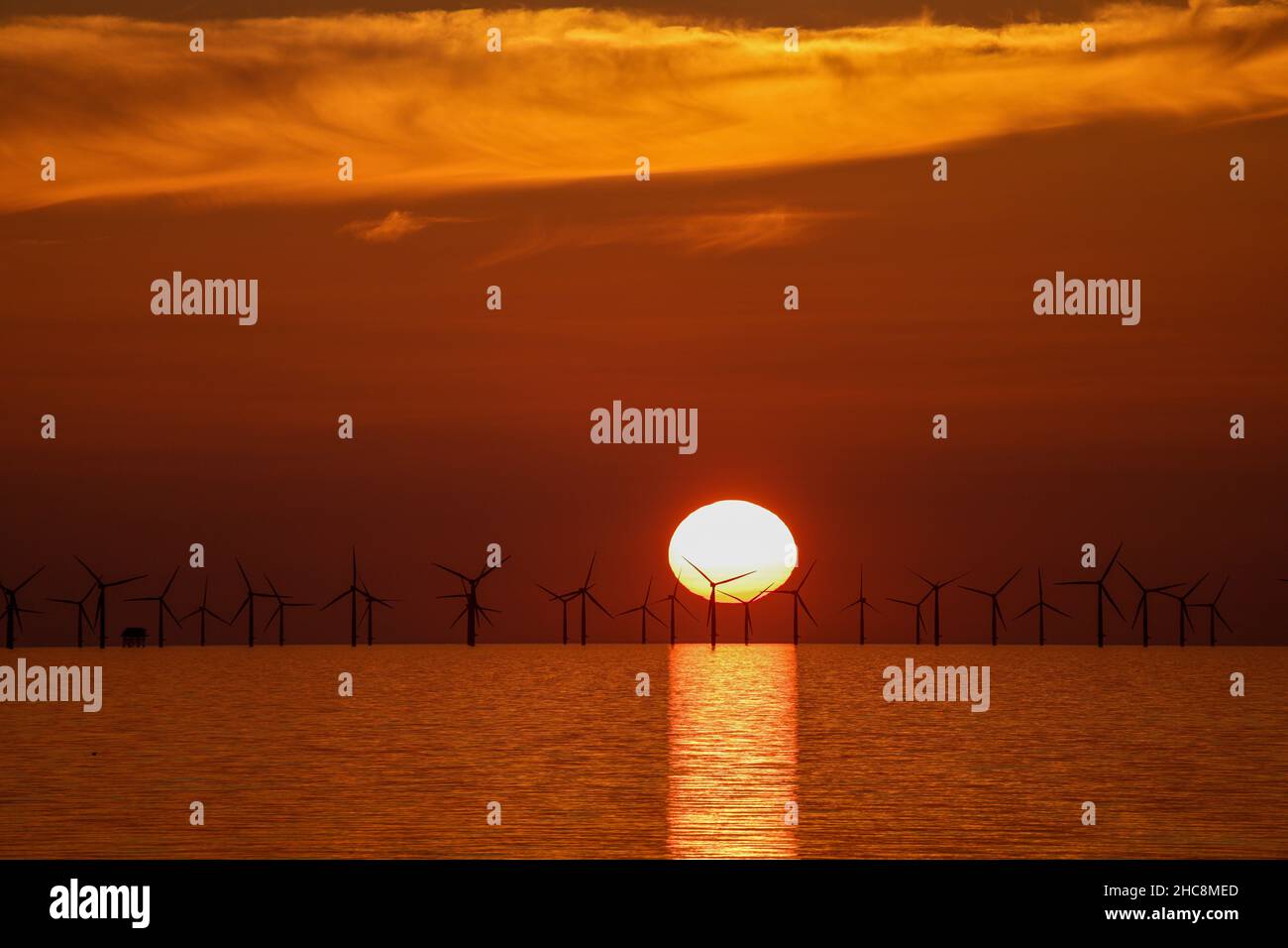 Sunset over the Gwynt-y-Môr offshore wind farm, Colwyn Bay, North Wales Stock Photo