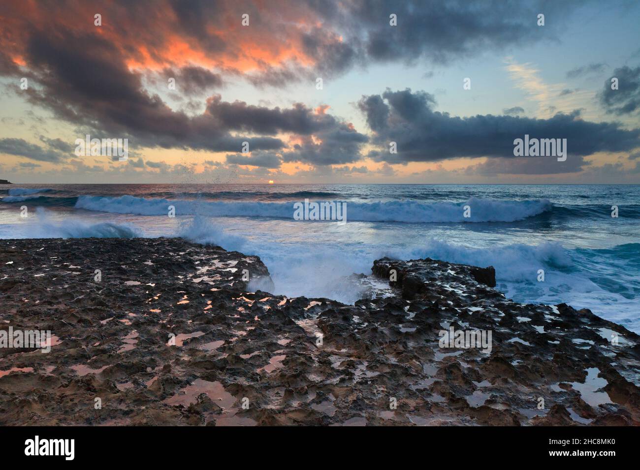 Sunset and waves crashing onto the rocky coastline in winter, Akamas peninsula, Island of Cyprus, eastern Mediterranean Stock Photo