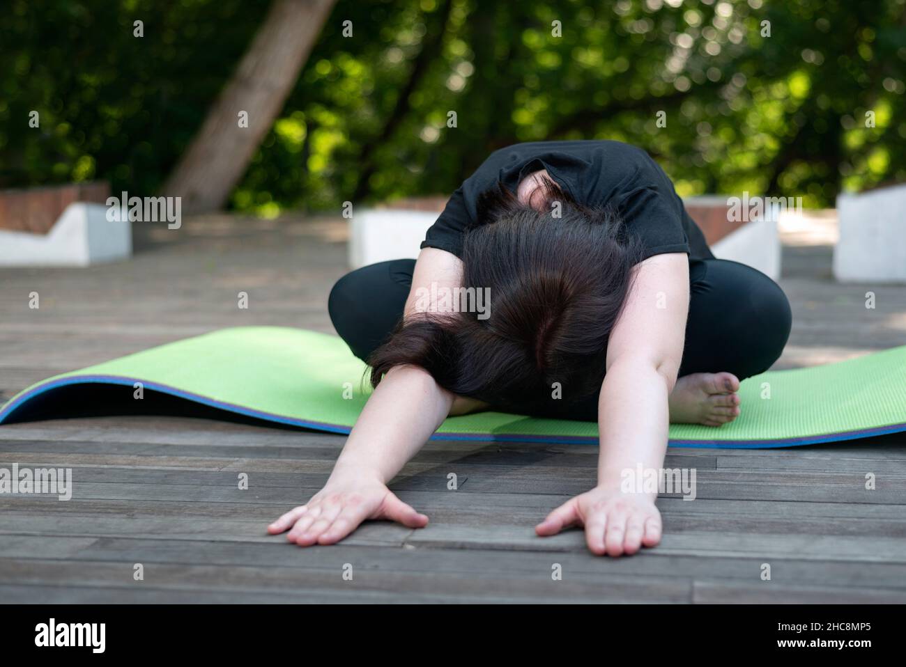 Young beautiful girl makes a lean forward from a sitting position