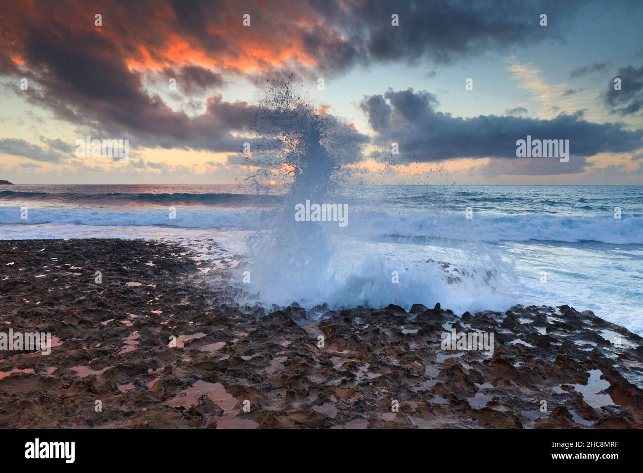 Sunset and waves crashing onto the rocky coastline in winter, Akamas peninsula, Island of Cyprus, eastern Mediterranean Stock Photo