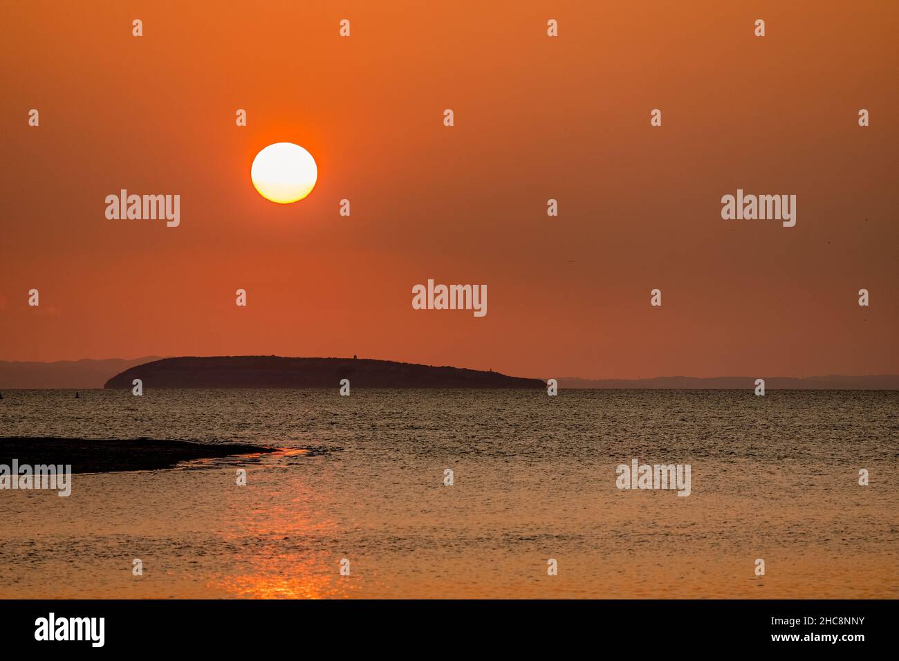 Sunset over Puffin Island from Deganwy, North Wales Stock Photo