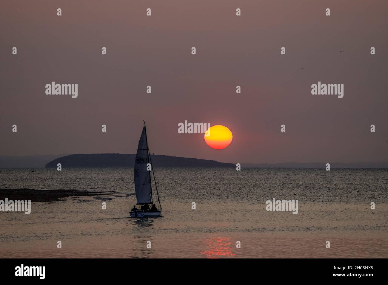 Sunset with yacht, Deganwy, North Wales Stock Photo