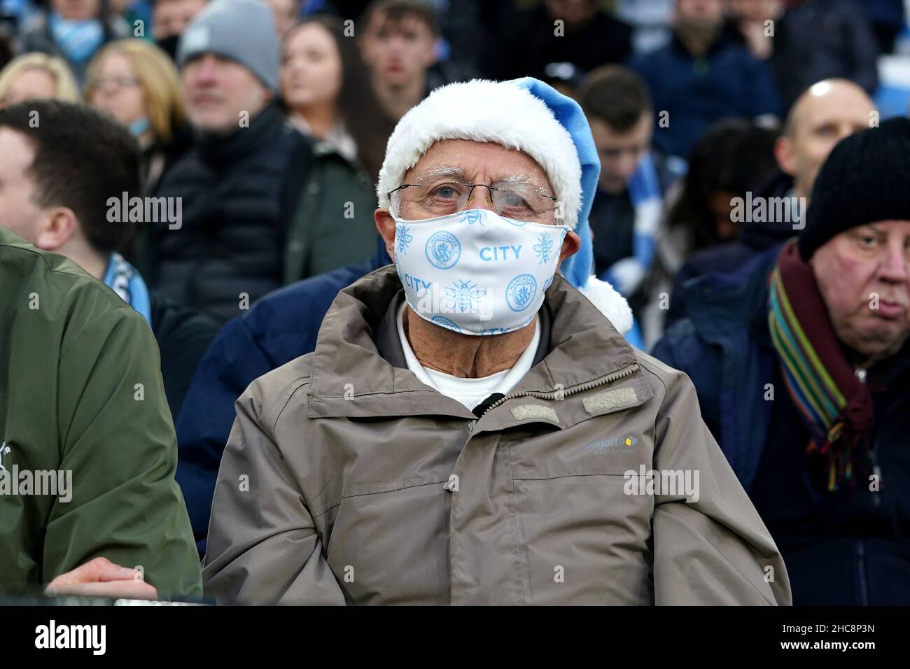 Manchester City fans with face masks on ahead of the Premier League