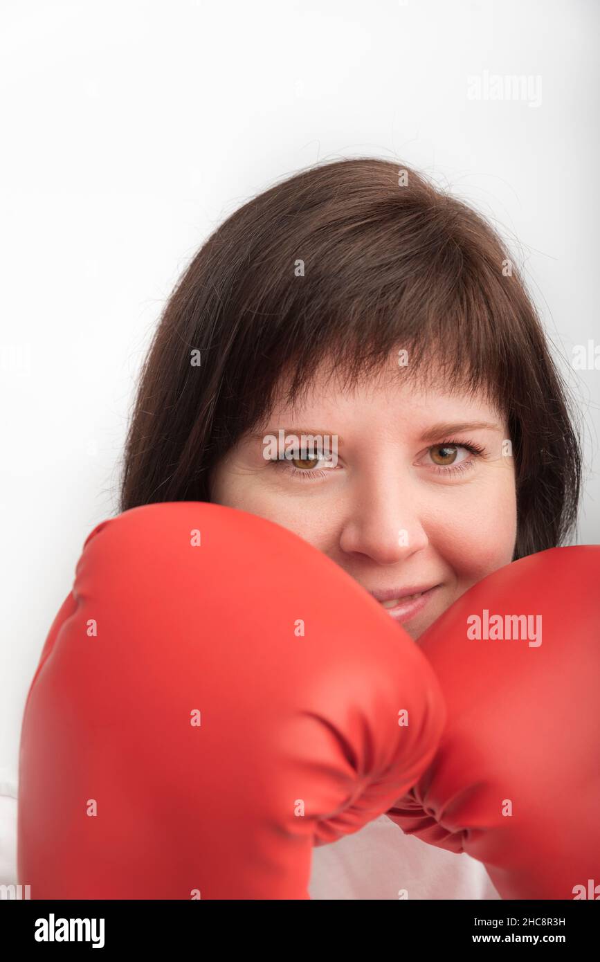 Closeup portrait of young darkhaired woman in red wrestling gloves