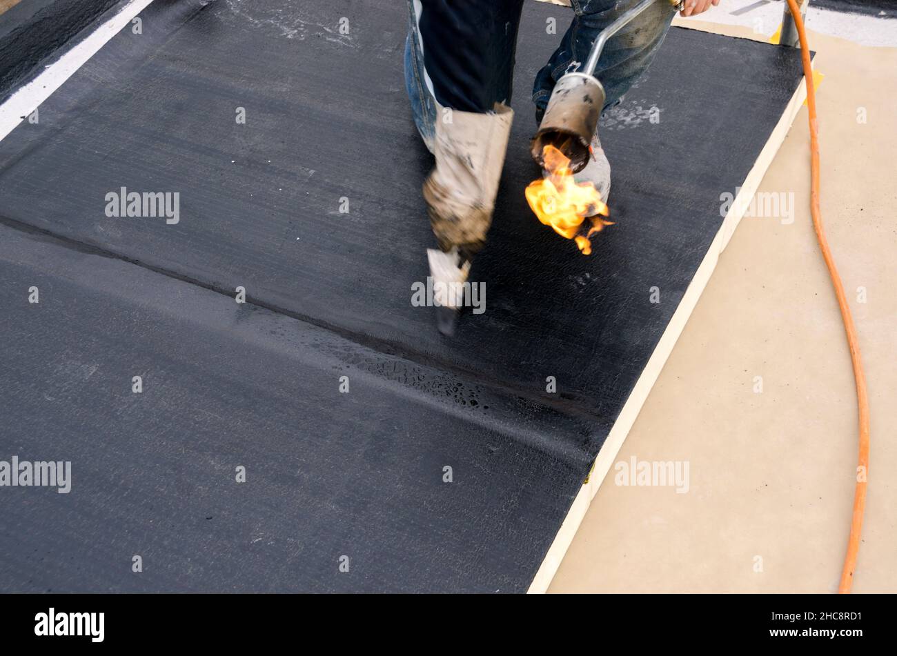 laying of waterproofing sheathing and insulation during the renovation of a roof in Italy Stock