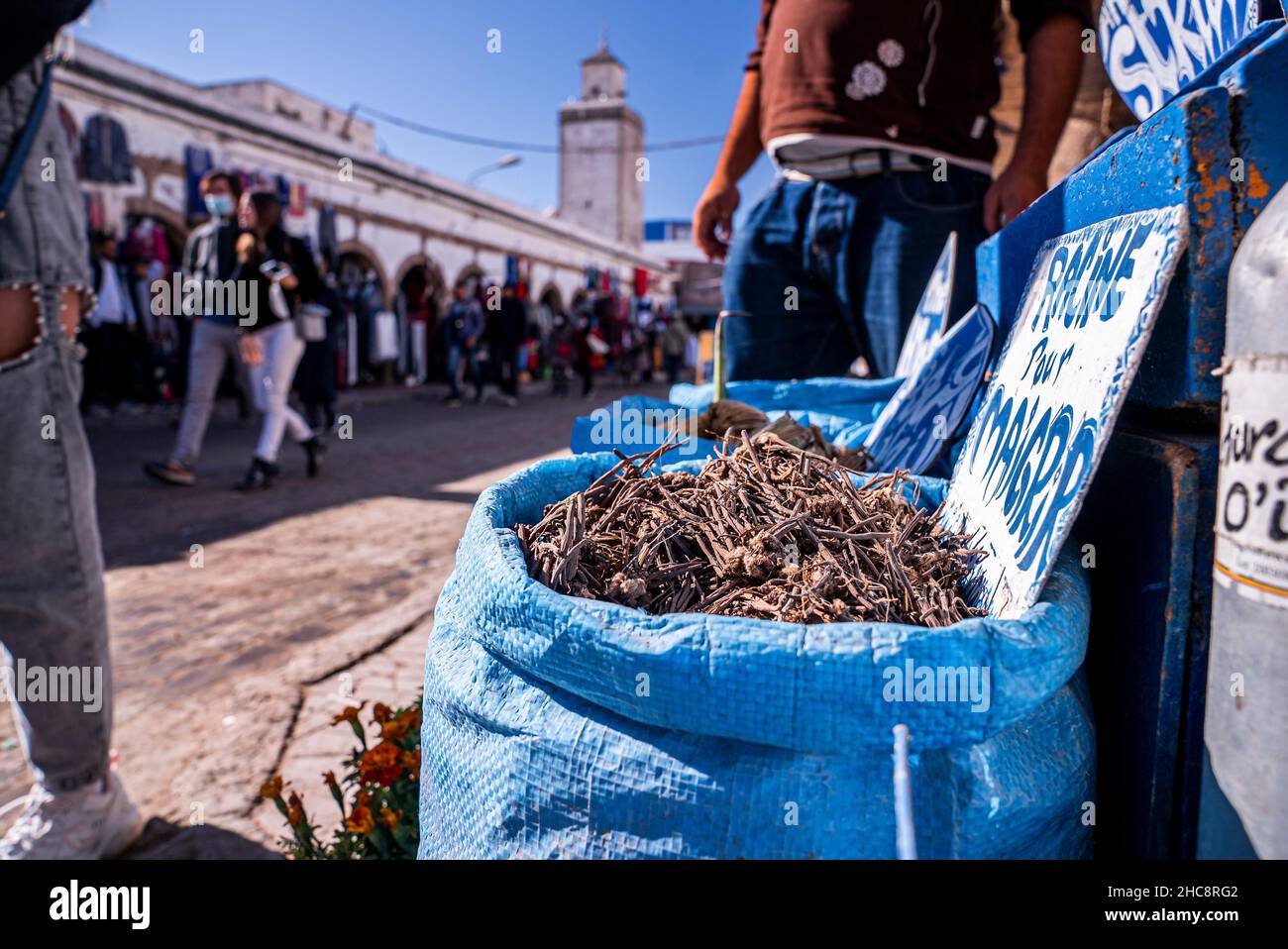 Closeup of dry roots in sack at market for sale on street on sunny day Stock Photo