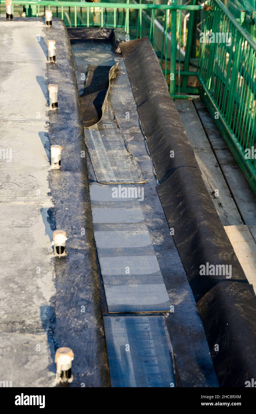 laying of waterproofing sheathing  and insulation during the renovation of a roof in Italy Stock Photo
