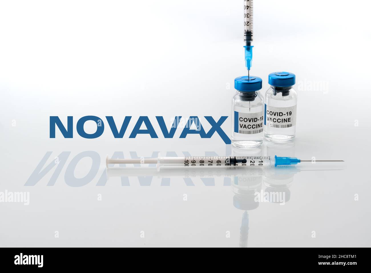 Turin, Italy - December 18, 2021: vials of covid-19 vaccine with syringes in the background Novavax Laboratory logo, protein vaccine, vaccination conc Stock Photo