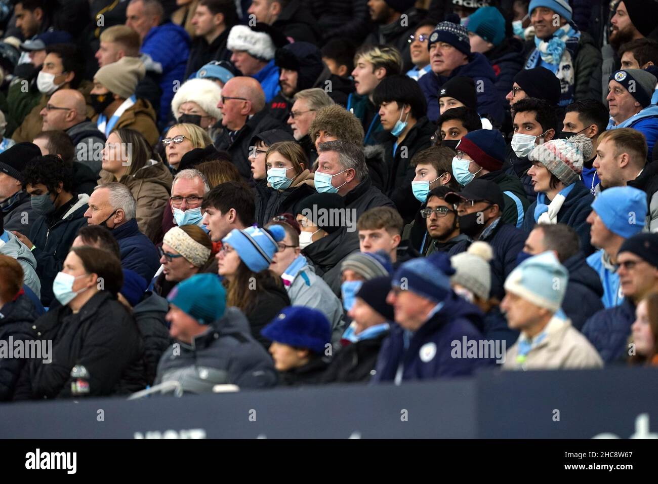 Manchester City fans in the stands with face masks on during the