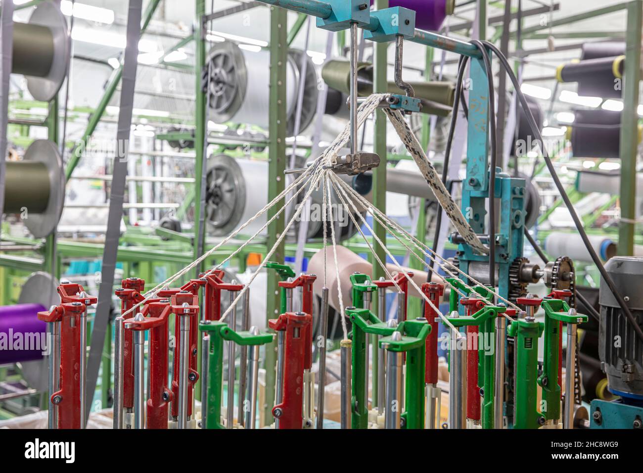 Narrow warp beams on the loom. Textile industry. Spinning spool on a  spinning machine in a textile factory Stock Photo - Alamy
