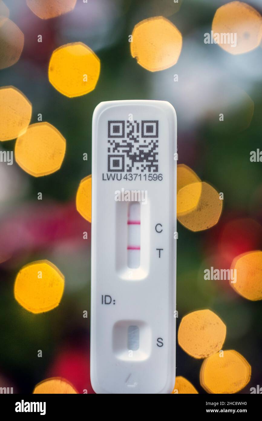 Home test kit for Coronavirus showing positiv result.Covid rising Omicron Christmas cases. Stock Photo