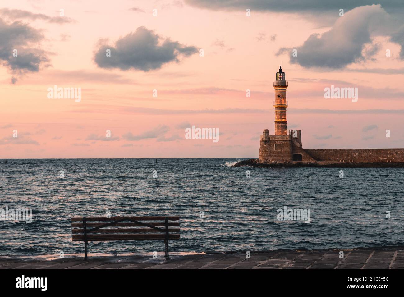 Sunset at the lighthouse of the Venetian port in old town of Chania - Crete Island, Greece Stock Photo