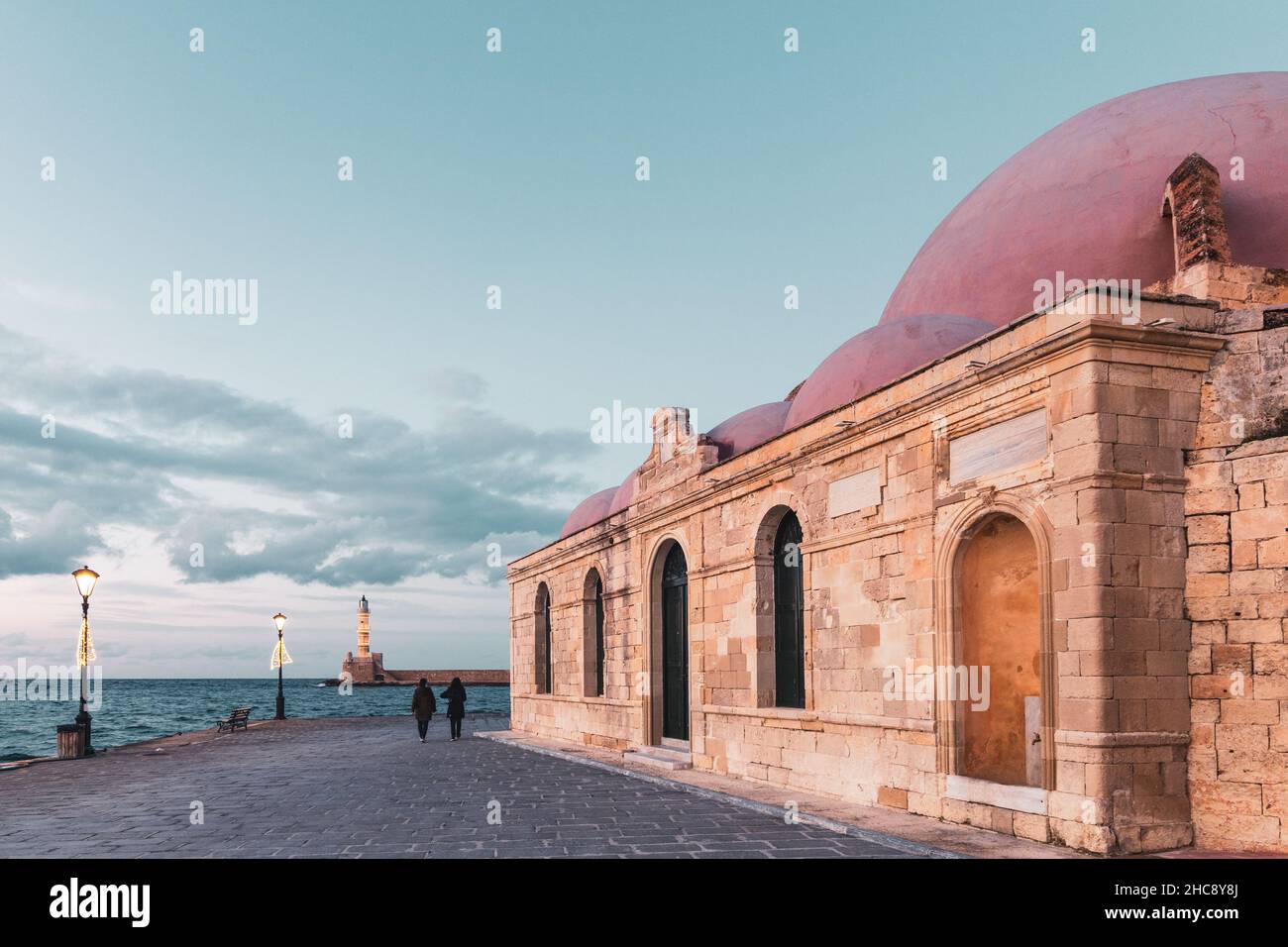 Chania Hassan Pascha Mosque and lighthouse at sunseut at the Venetian port - Crete Island, Greece Stock Photo