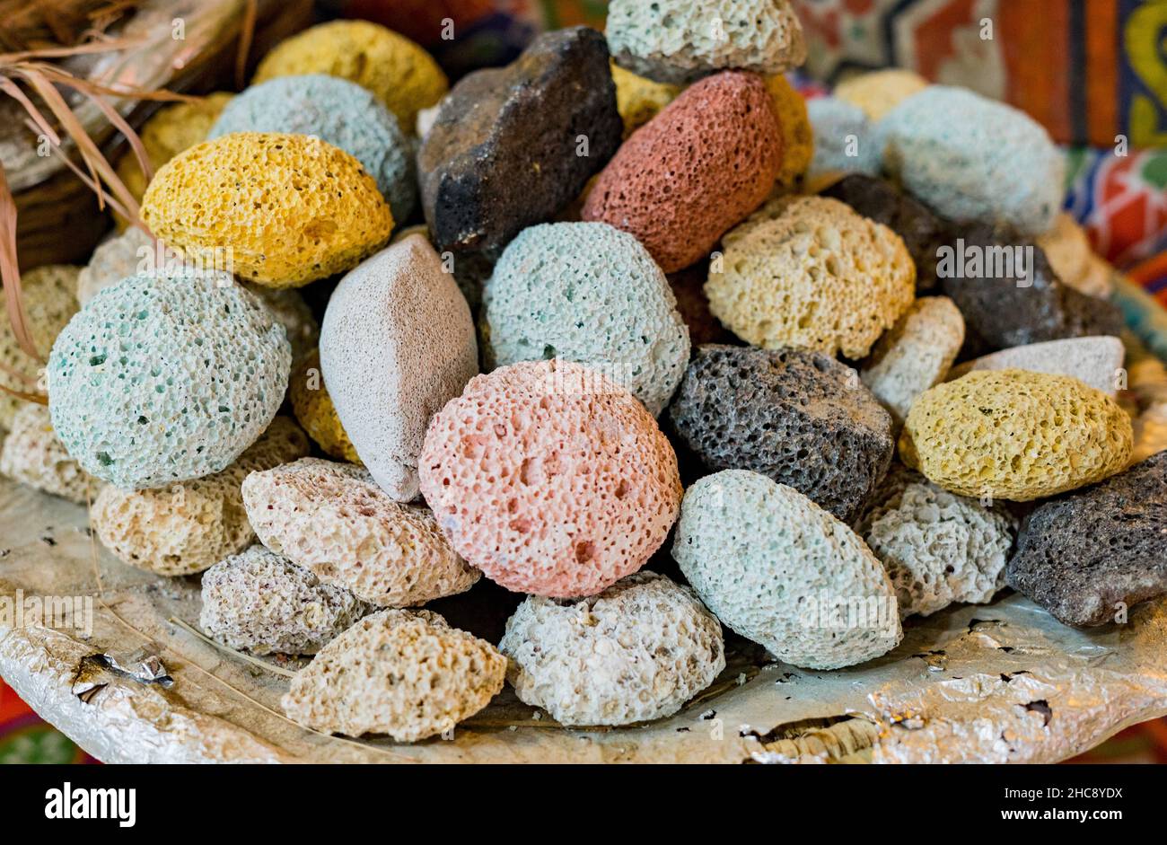 Colored pumice stones for feet in basket as souvenirs for tourists