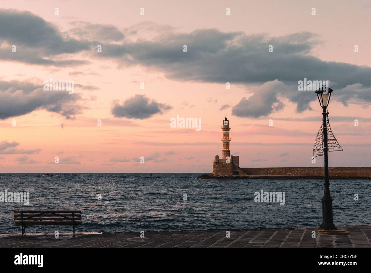 Beautiful red sunset at the lighthouse of the Venetian port in old town of Chania - Crete Island, Greece Stock Photo