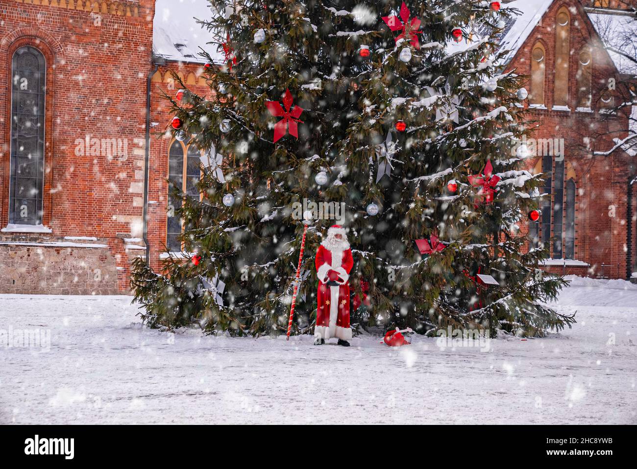 Santa Claus walking by the huge Christmas tree in Riga, Latvia Stock