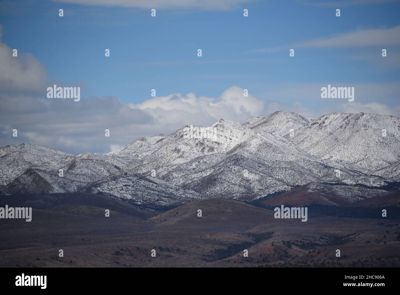 Large format panoramic landscape of red desert snow covered mountain range in the wilderness of Southern Utah, USA. Stock Photo
