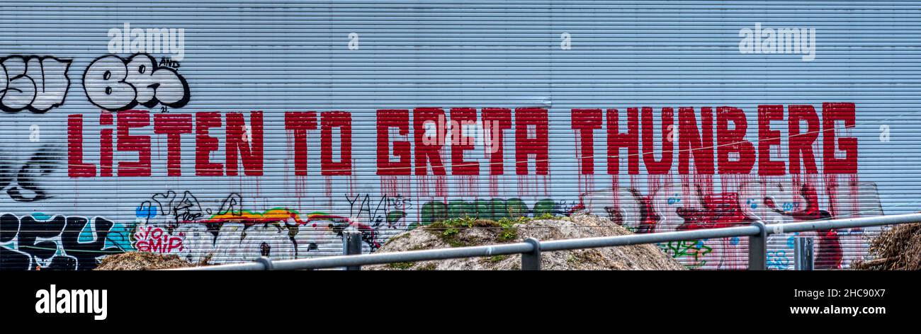 poster with red liquid letters on a gray aluminum wall listen to Greta Thunberg, Copenhagen, September 11, 2021 Stock Photo