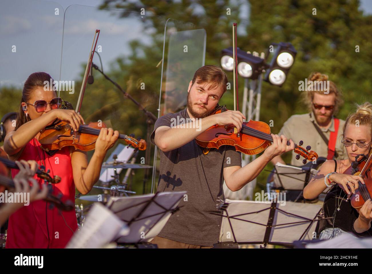 Violin players playing classic music at outdoor concert Stock Photo