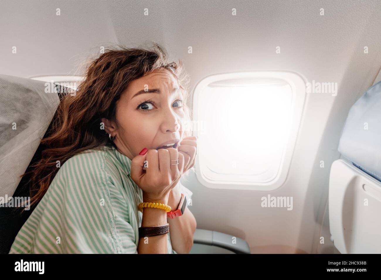 Woman with aerophobia is afraid to fly on an airplane and experiences a