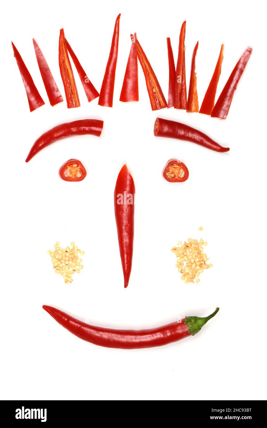 Red hot chili pepper on white, funny face made of chili. Creative food