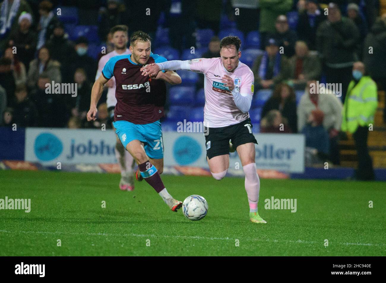 BIRKENHEAD, UK DEC 26TH Josh Kay of Barrow FC is tackled by Kyle Hayde