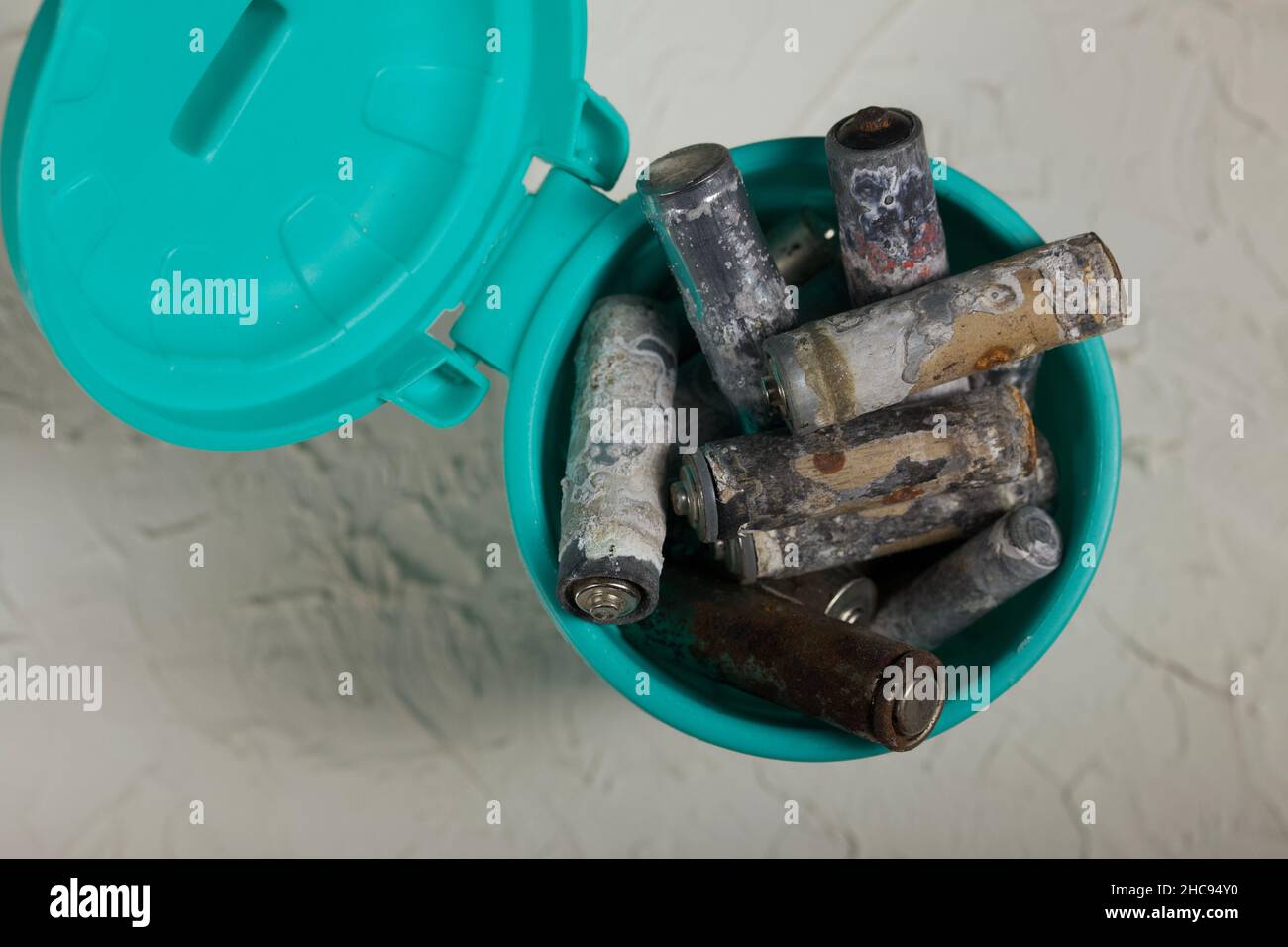 Corroded waste batteries. Fingertype batteries and accumulators for disposal. They lie in a