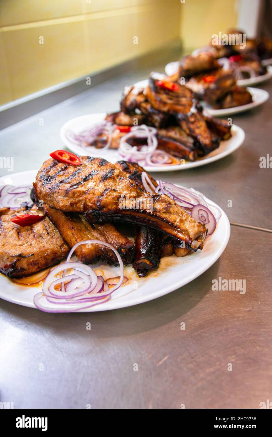 BBQ grill ribs served in portions in the restaurant kitchen. Plates