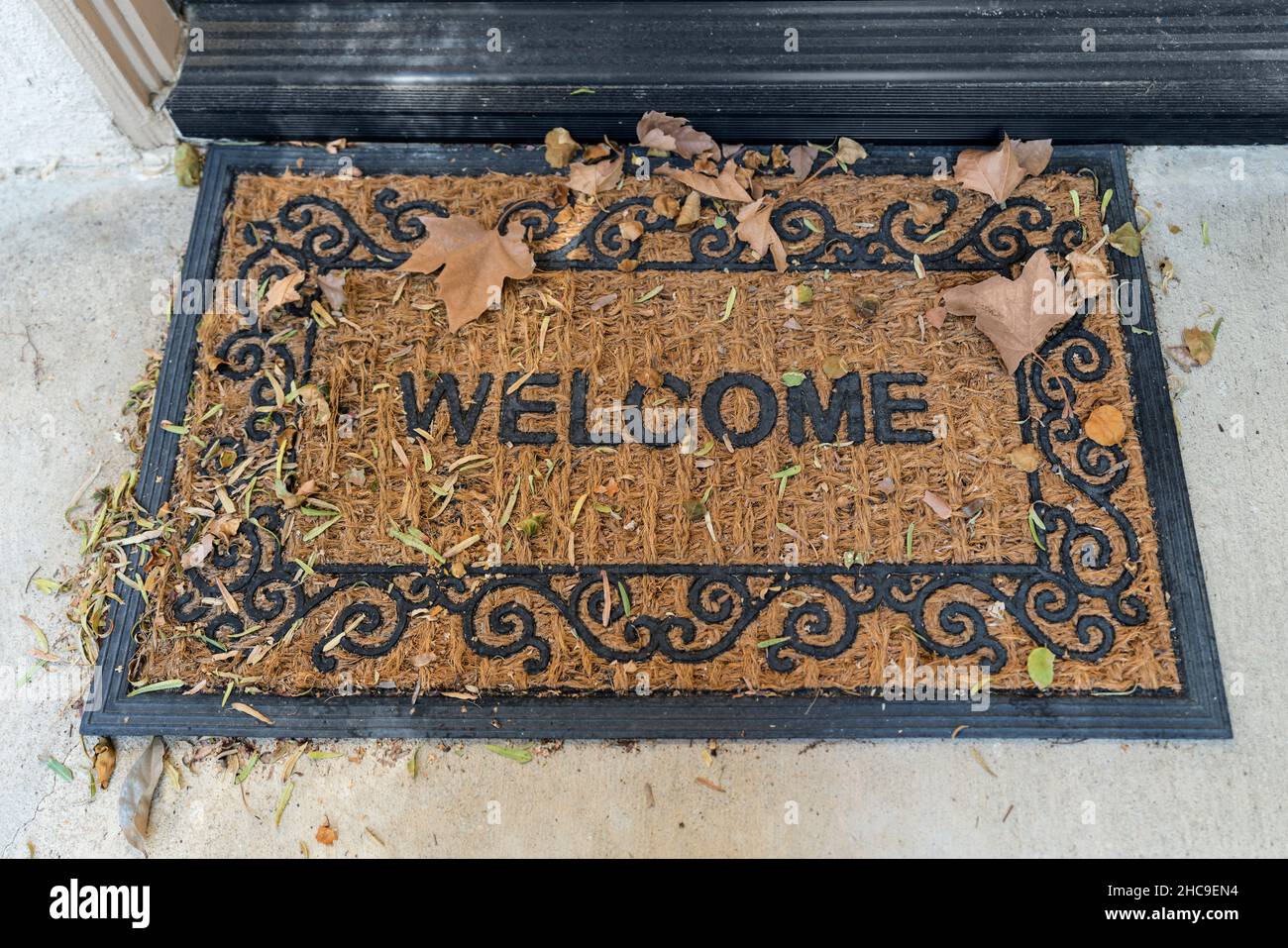 mat with autumn leaves outside suburban front door Stock Photo Alamy