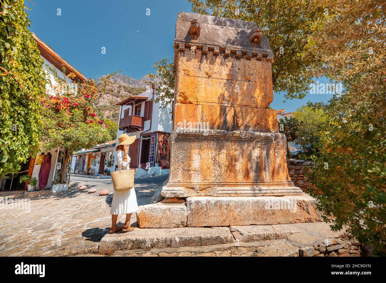 Traveler woman explores Lycian King tomb on the streets of the small tourist town of Kas. Sightseeing and vacation in Turkey Stock Photo