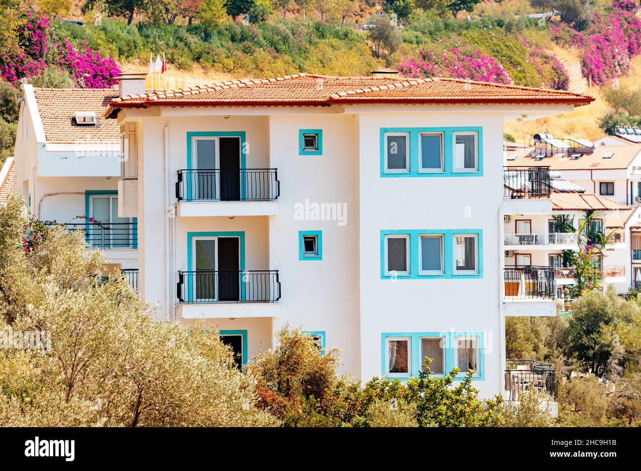 Houses and villas with red roofs in a resort town on mountain steep