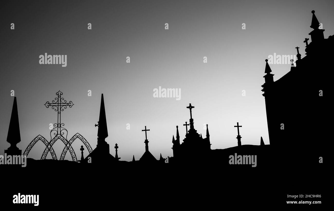 Silhouettes of crosses in a night cemetery. Black and white photo. Stock Photo