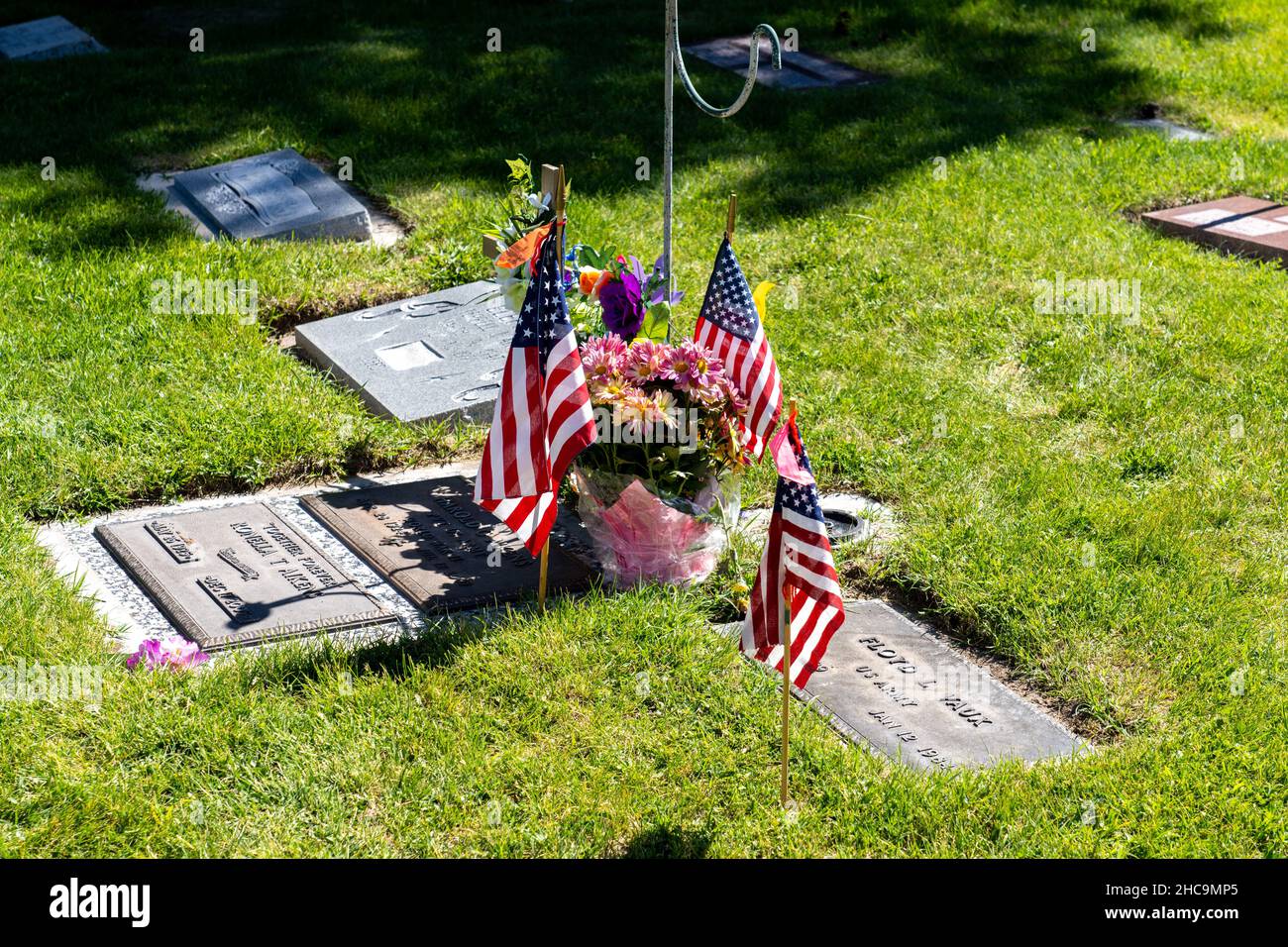 American flags and flowers decorate graves for the Memorial Day Holiday