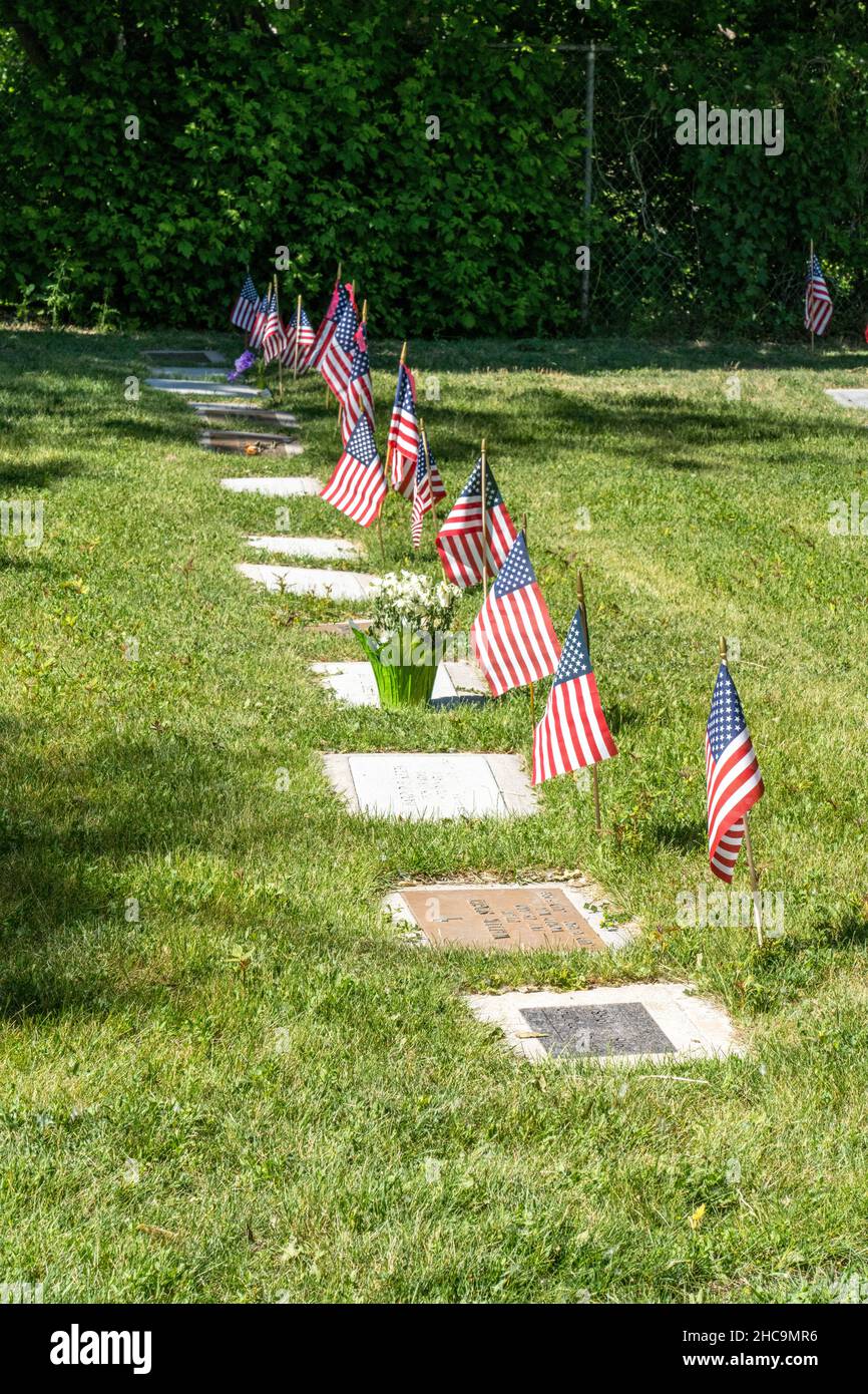 American flags and flowers decorate graves for the Memorial Day Holiday